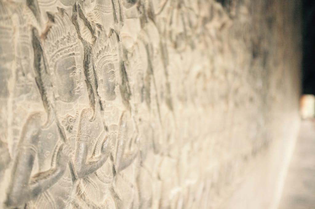 Figures on a stone wall decoration.