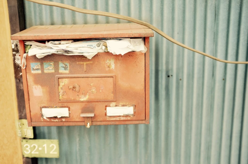 mailbox stuffed with old letters and papers.